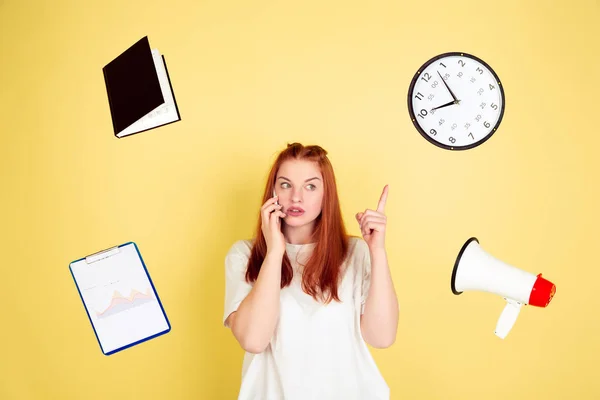 Caucasian young womans portrait on yellow background, too much tasks — 스톡 사진