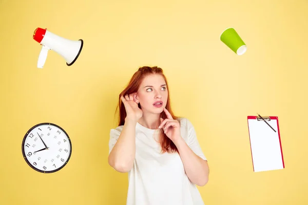 Caucasian young womans portrait on yellow background, too much tasks — 스톡 사진