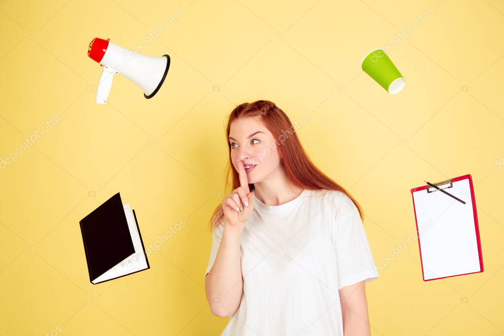 Caucasian young womans portrait on yellow background, too much tasks