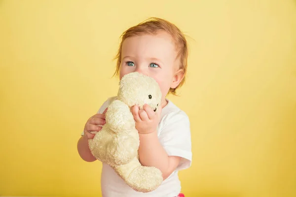 Caucasian little girl, children isolated on yellow studio background — 스톡 사진