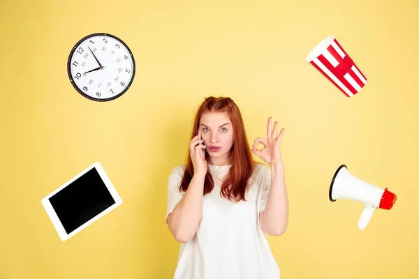 Caucasian young womans portrait on yellow background, too much tasks — 스톡 사진