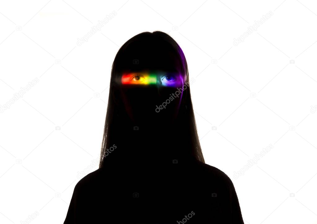 Dramatic portrait of a girl in the dark on white studio background with rainbow colored line