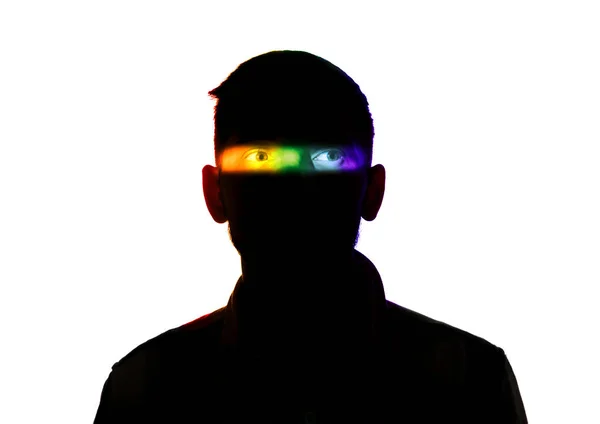 Dramatic portrait of a man in the dark on white studio background with rainbow colored line — 스톡 사진