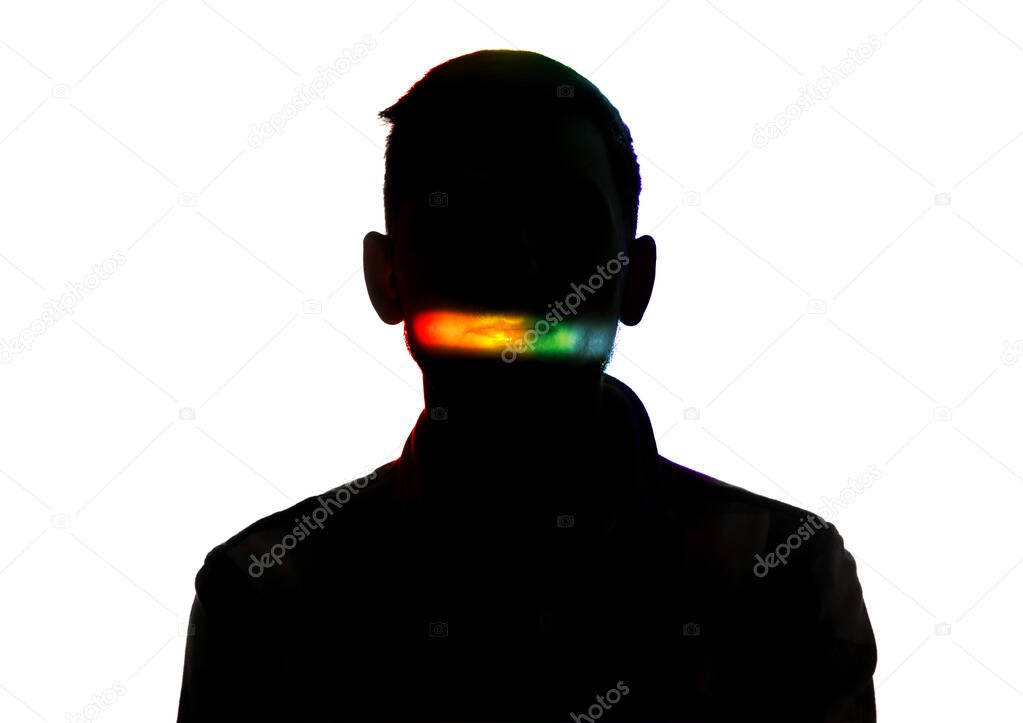 Dramatic portrait of a man in the dark on white studio background with rainbow colored line