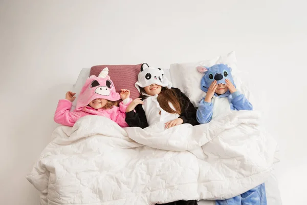 Children in soft warm pajamas having party colored bright playing at home — Stock Photo, Image