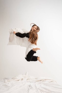 Little girl in soft warm pajama having party colored bright playing at home