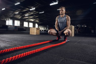 Spor salonunda egzersiz yapan sağlıklı genç bir erkek atlet.