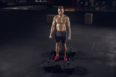 Spor salonunda egzersiz yapan sağlıklı genç bir erkek atlet.