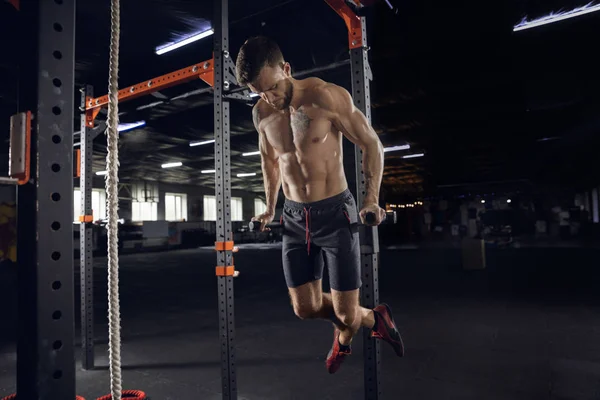 Jeune athlète masculin en bonne santé faisant des exercices dans la salle de gym — Photo