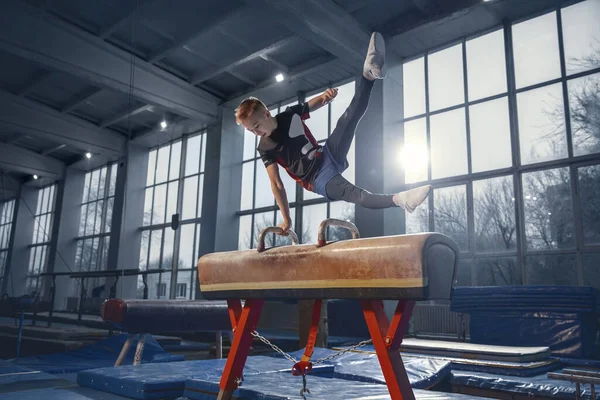 Pequeño entrenamiento de gimnasta masculino en gimnasio, flexible y activo —  Fotos de Stock