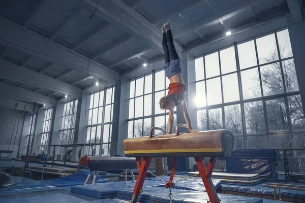 Spor salonunda küçük bir erkek jimnastikçi, esnek ve aktif. — Stok fotoğraf