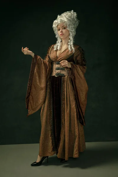 Medieval young woman in old-fashioned costume