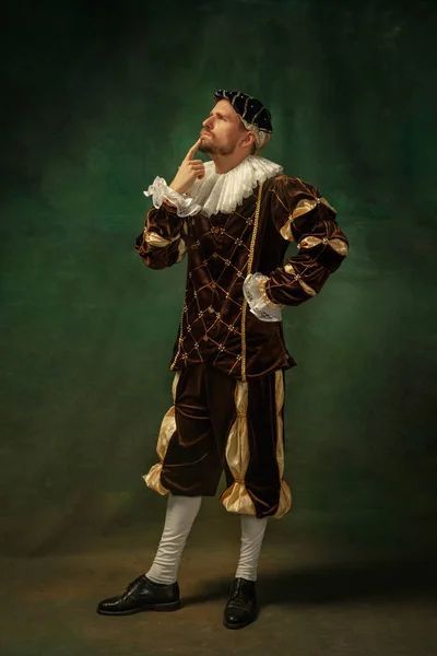 Medieval young man in old-fashioned costume