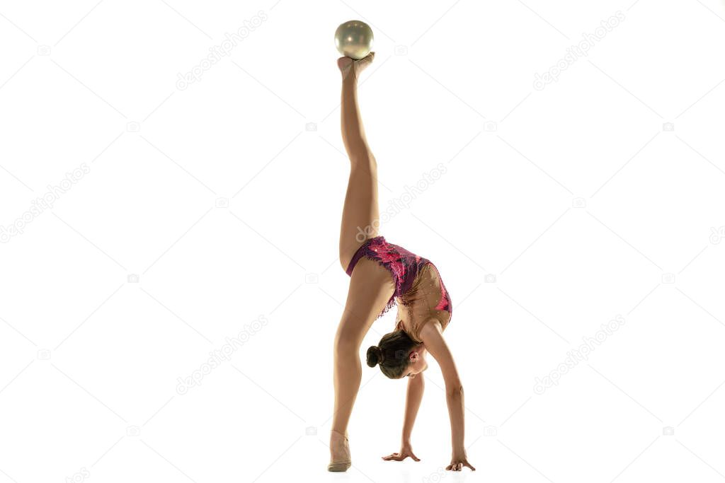 Young flexible female gymnast isolated on white studio background