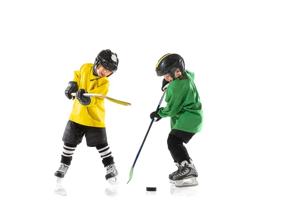 Små hockeyspelare med pinnar på isbana och vit studio bakgrund — Stockfoto