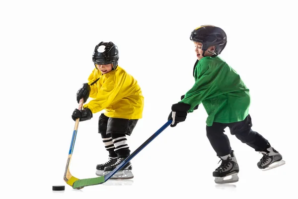 Små hockeyspelare med pinnar på isbana och vit studio bakgrund — Stockfoto