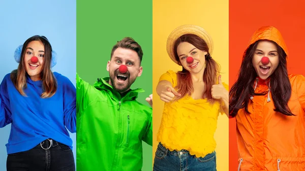 Portrait of young people celebrating red nose day on colorful background — 스톡 사진