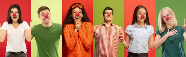 Retrato de jovens celebrando dia nariz vermelho em fundo colorido — Fotografia de Stock