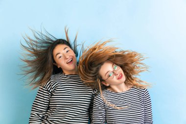 Değişken mavi arka planda genç duygusal kadınlar