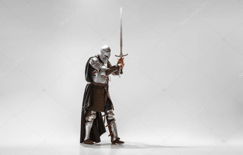 Brave armored knight fighting isolated on white studio background