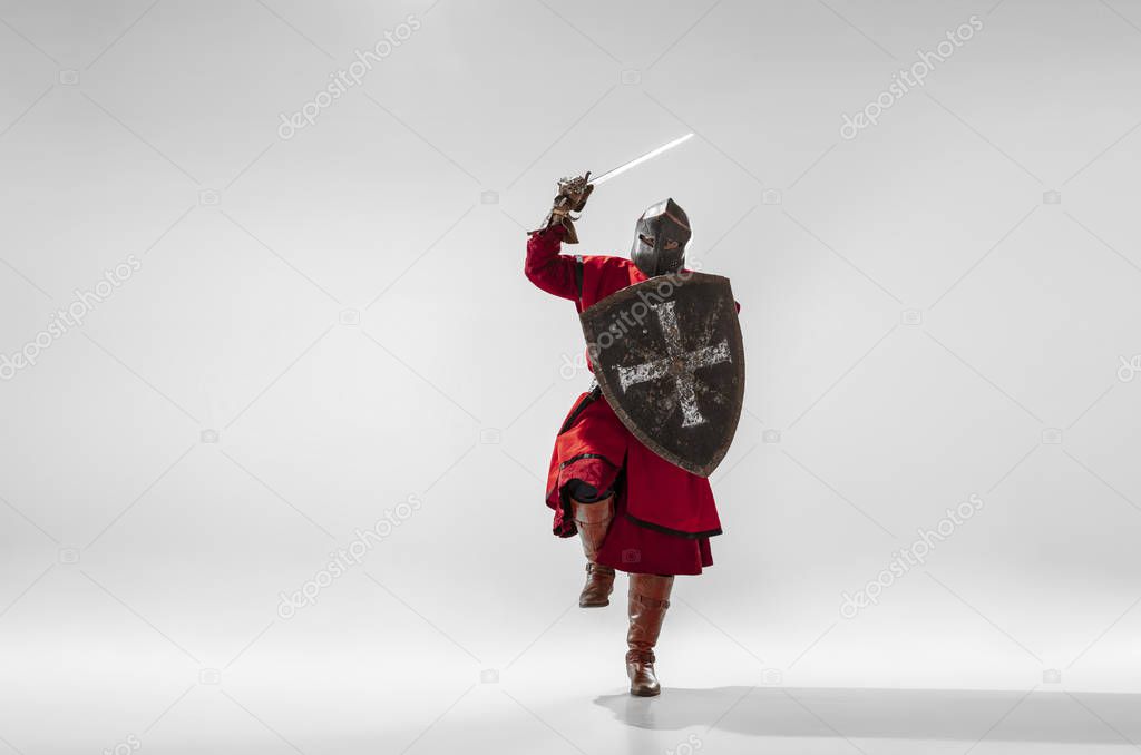 Brave armored knight fighting isolated on white studio background