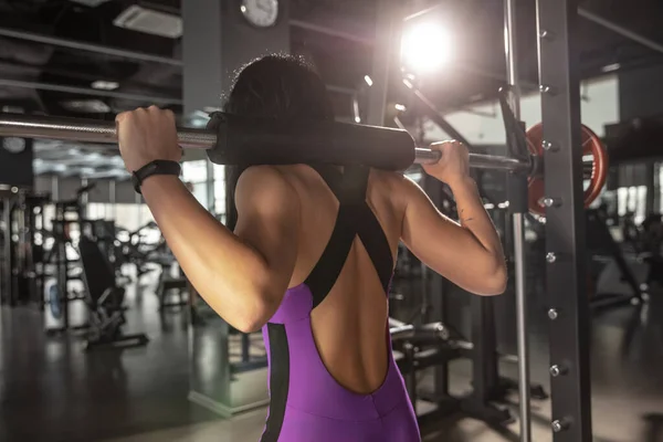 The female athlete training hard in the gym. Fitness and healthy life concept.