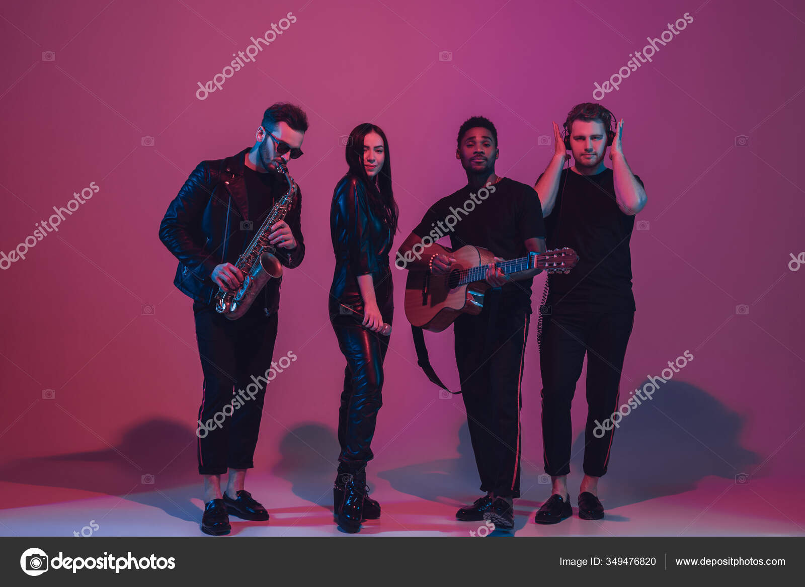 Group of young multiethnic musicians created band, dancing in neon ...