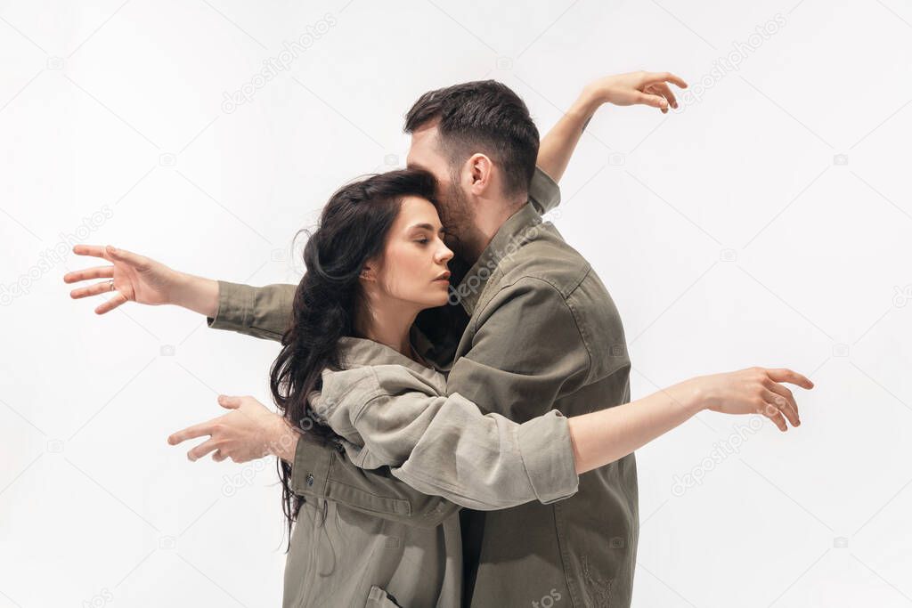 Trendy fashionable couple isolated on white studio background