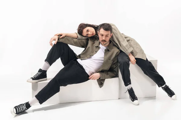 Trendy fashionable couple isolated on white studio background — Stock Photo, Image