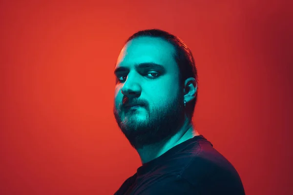 Portrait of a guy with colorful neon light on red background - cyberpunk concept — 스톡 사진