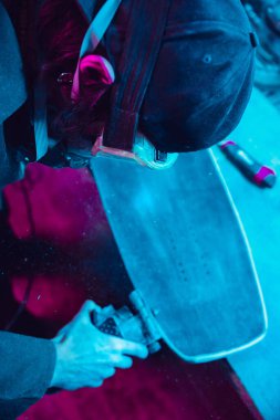 Skater in process of making his own skateboard, longboard - open business concept