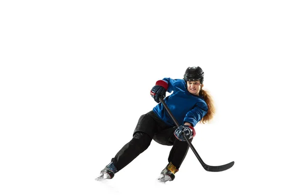 Young female hockey player with the stick on ice court and white background — Stock Photo, Image
