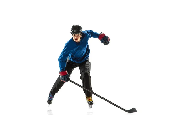 Young female hockey player with the stick on ice court and white background — Stock Photo, Image