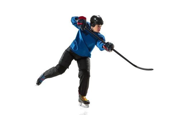 Young female hockey player with the stick on ice court and white background — Stock Photo, Image