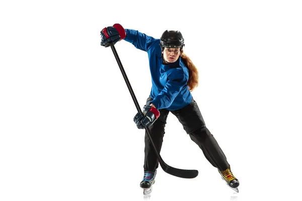 Young female hockey player with the stick on ice court and white background — Stock Photo, Image