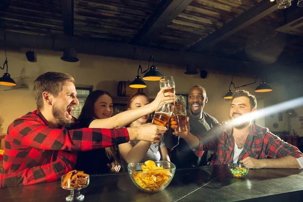 Sport fans juichen in de bar, pub en het drinken van bier, terwijl het kampioenschap, de concurrentie gaat — Stockfoto