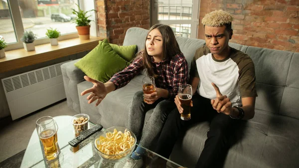 Excited couple, friends watching sport match, championship at home