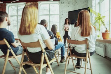 Kadın Afro-Amerikan konuşmacı üniversite atölyesinde sunum yapıyor.