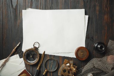 Eski moda daire, harflerle kaplıydı. Koyu ahşap arka plana aksesuarlar yazıyordu.