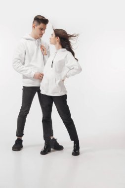Trendy fashionable couple isolated on white studio background clipart