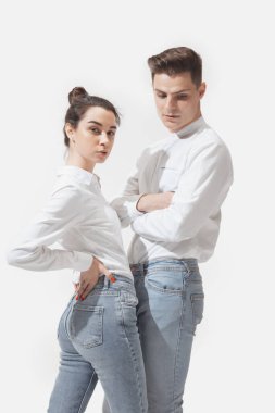 Trendy fashionable couple isolated on white studio background clipart