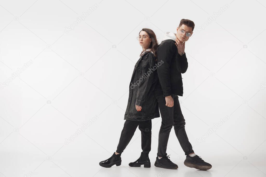 Trendy fashionable couple isolated on white studio background