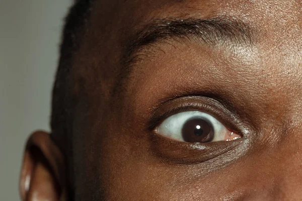Close-up de rosto de belo jovem afro-americano, foco nos olhos — Fotografia de Stock