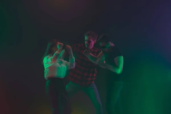 Cheering dance party, performance concept. Crowd shadow of people dancing with neon lights raised hands up — Stock Photo, Image