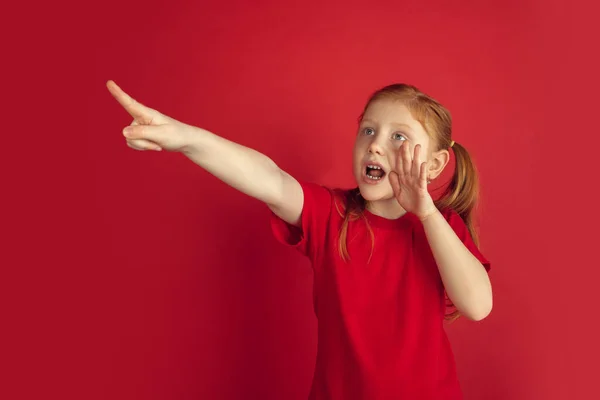 Vit liten flicka porträtt isolerad på röd studio bakgrund, känslor koncept — Stockfoto