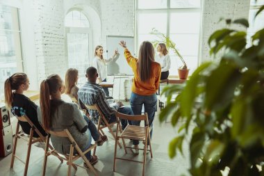 Beyaz kadın konuşmacı üniversite veya iş merkezi atölyesinde sunum yapıyor