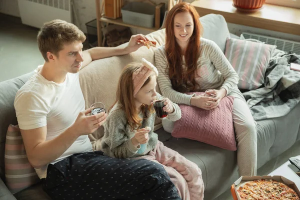 Familia pasar un buen tiempo juntos en casa, se ve feliz y alegre, comer pizza —  Fotos de Stock