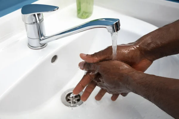 Az ember óvatosan mos kezet a fürdőszobában, közelről. A fertőzés és a tüdőgyulladás vírussal való terjedésének megelőzése — Stock Fotó