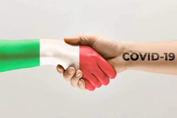 Human hands colored in flag of Italy and coronavirus - concept of spreading of virus — Stock Photo, Image
