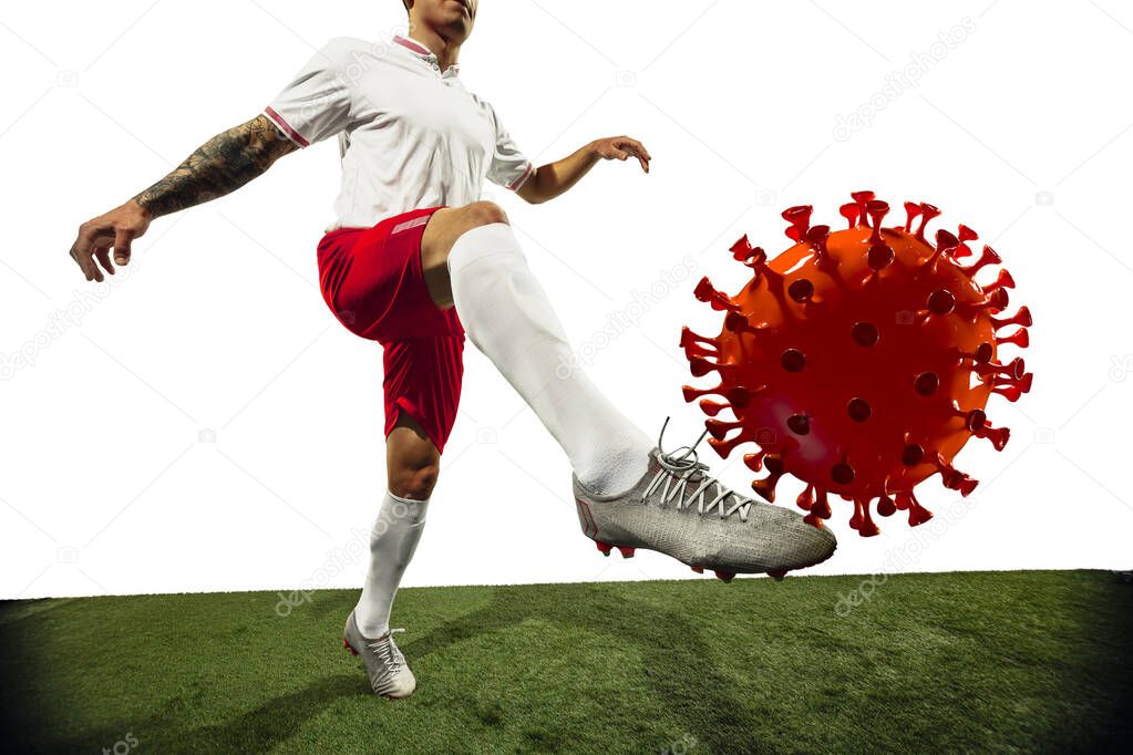 Football or soccer player kicking, punching model of coronavirus - fighting with epidemic concept